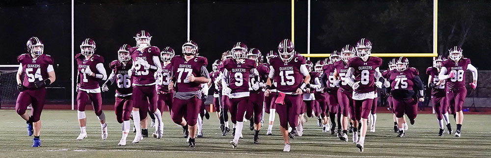 Orchard Park Quakers Football team hitting the field