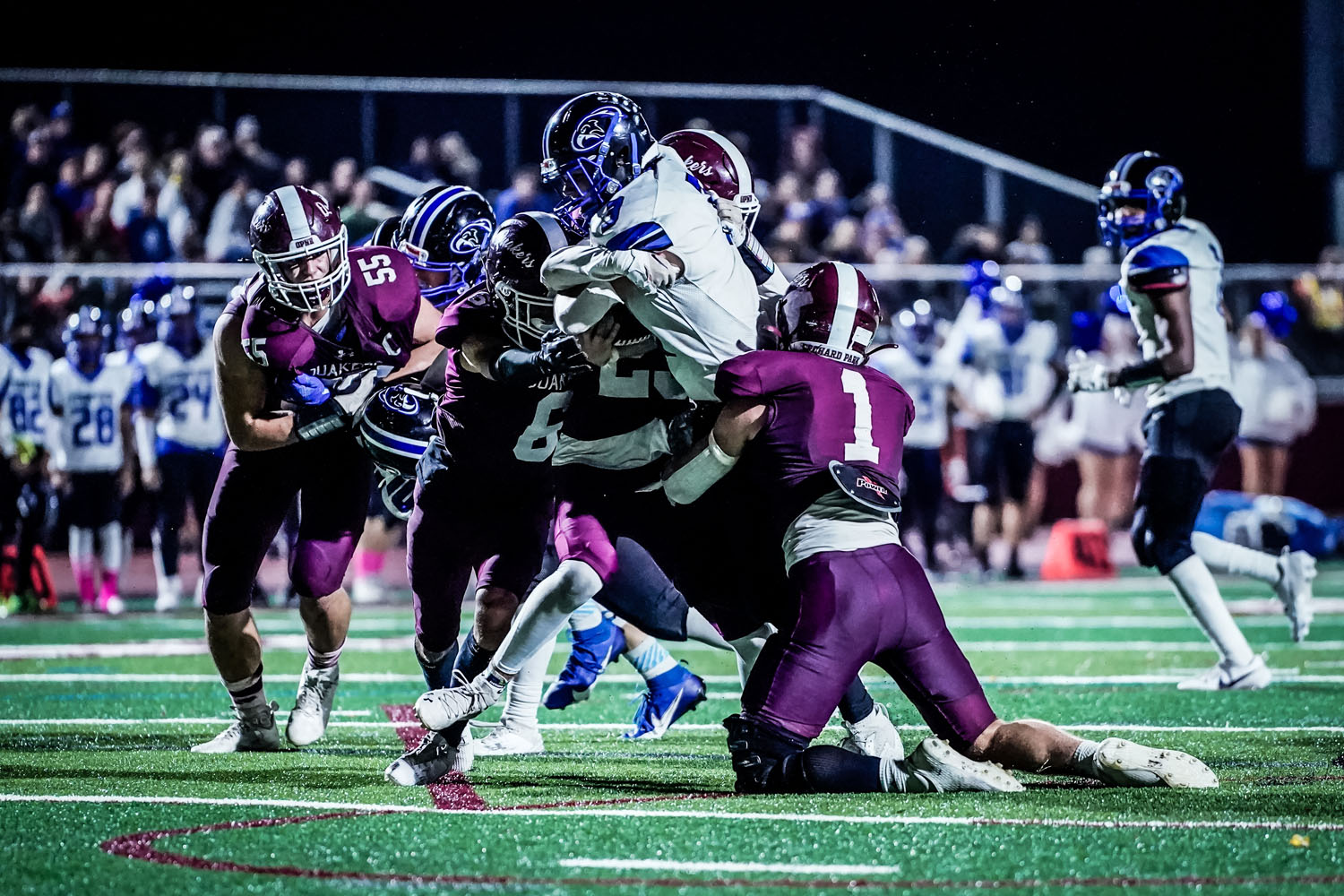 Defense making the tackle against Frontier