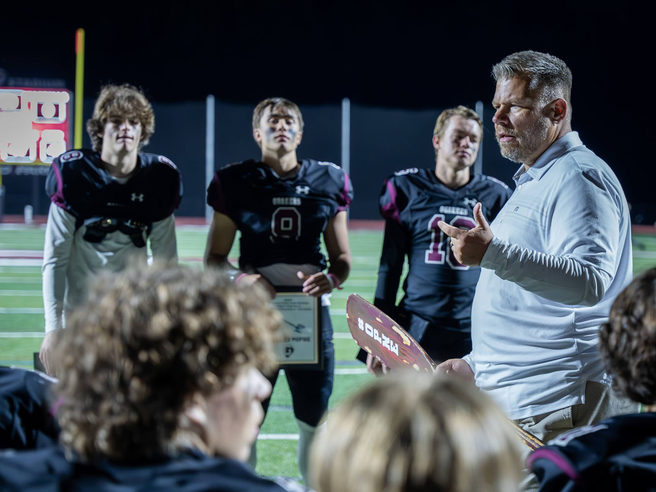 Coach talking to his team after a win