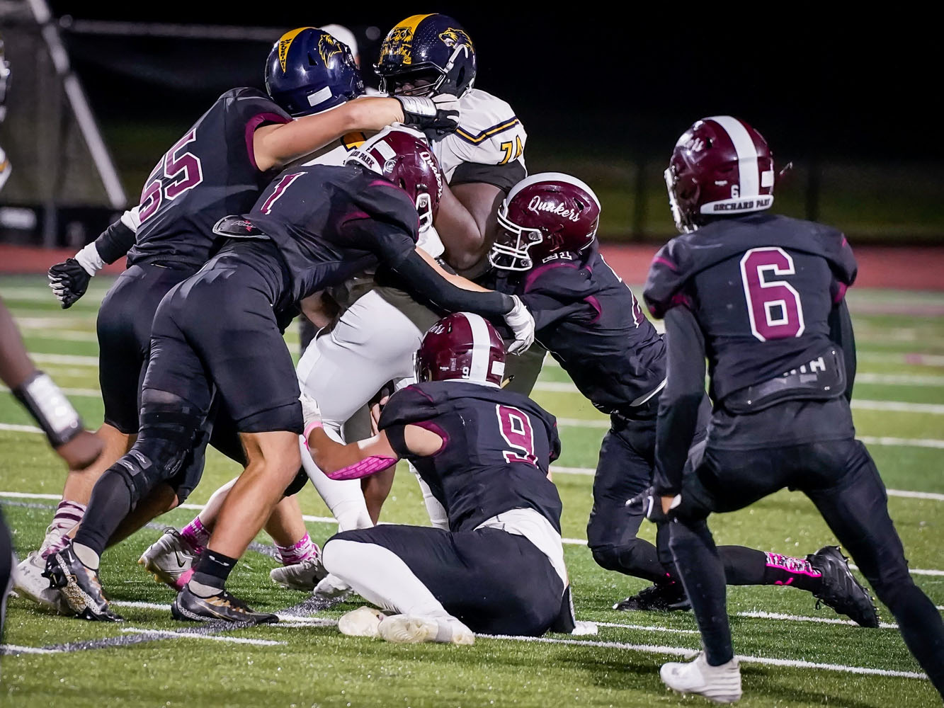 A gang of Quakers making the tackle against Niagara Falls