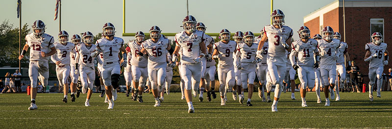 Orchard Park Quakers Football team hitting the field
