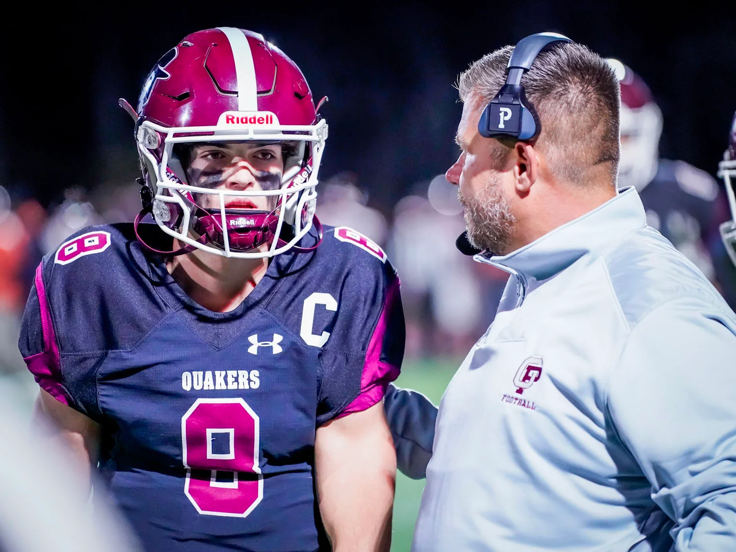 Coach talking to his QB