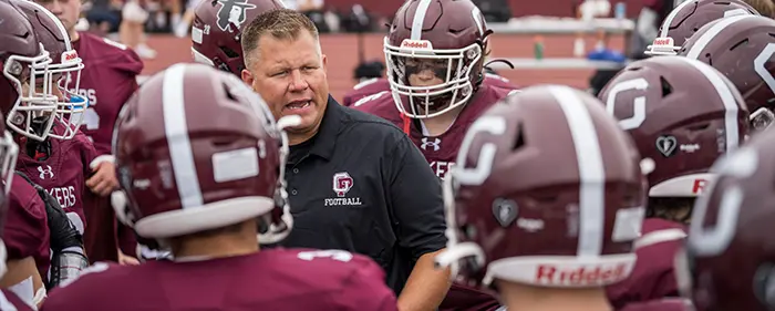 Head Coach talking to the team before the game