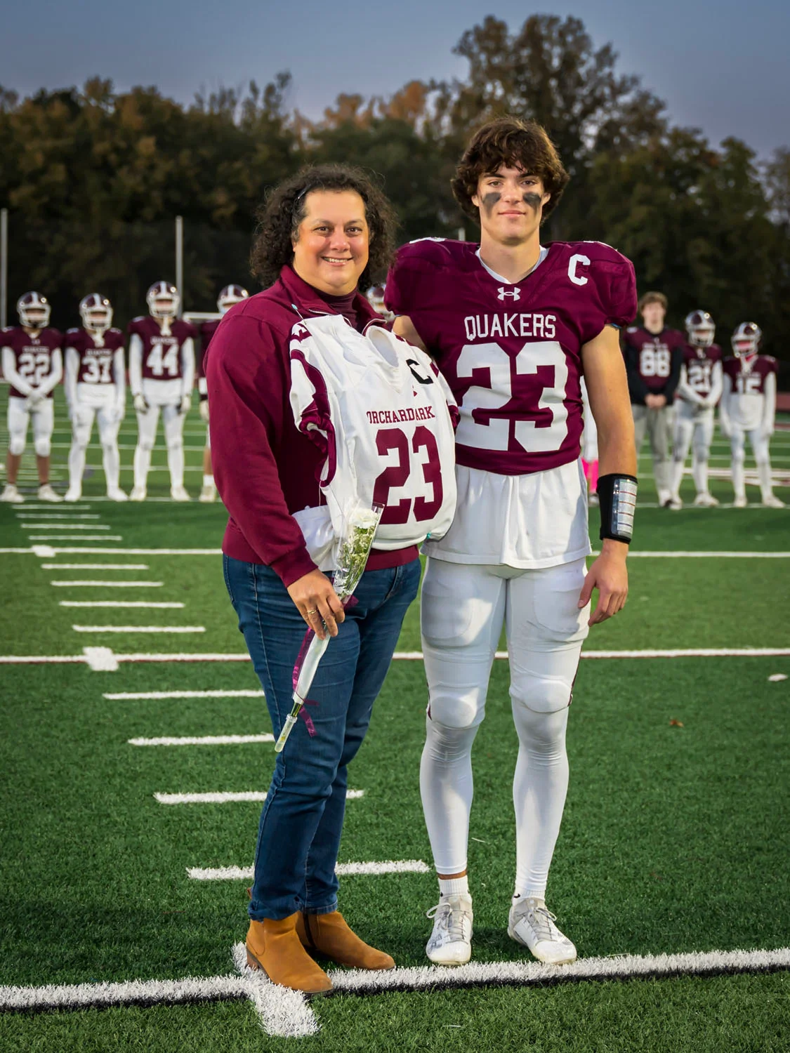 Teacher and player on Senior Night