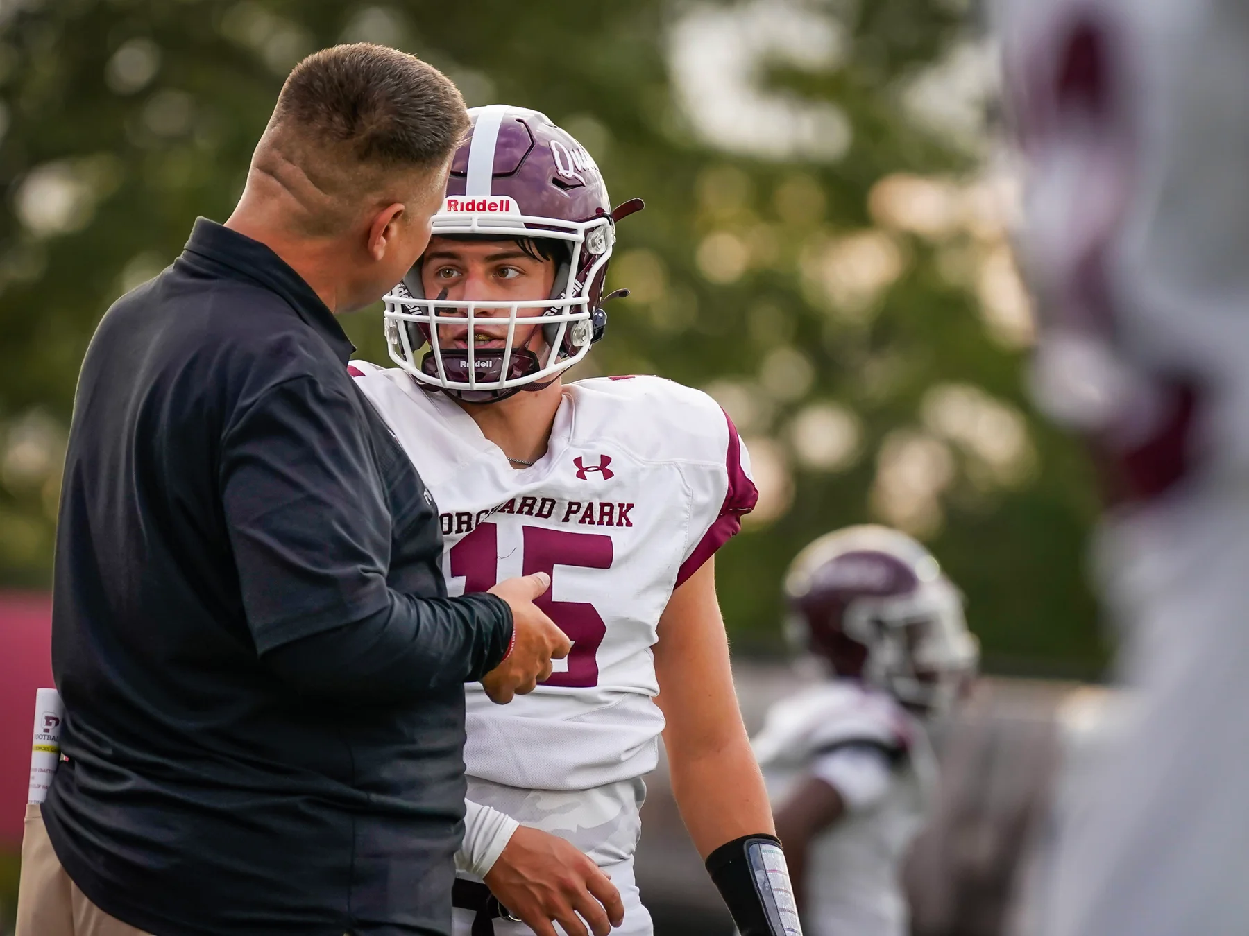 Coach talking to the QB