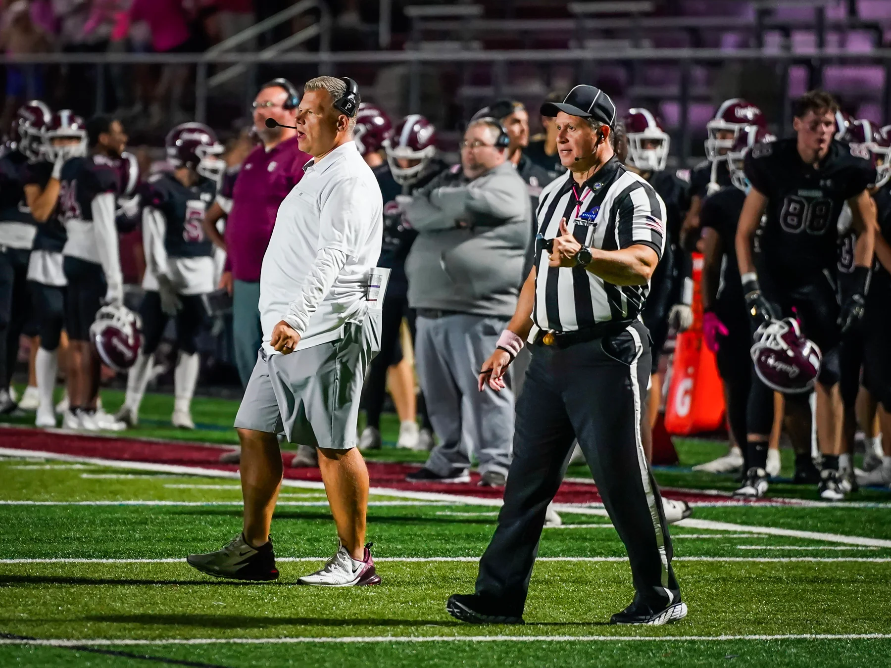 OP Coach talking to the team on the field